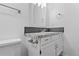 Bathroom boasts granite countertop and updated vanity at 3663 S Sheridan Blvd # I8, Denver, CO 80235