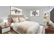Spacious bedroom with neutral decor, large window, and nightstands at 3663 S Sheridan Blvd # I8, Denver, CO 80235