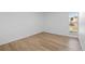 Bedroom with large window, light walls, and laminate flooring at 3663 S Sheridan Blvd # I8, Denver, CO 80235