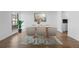 Dining area with a stylish table and chairs, hardwood floors at 3663 S Sheridan Blvd # I8, Denver, CO 80235