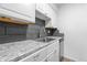 Kitchen features granite countertops and updated white cabinets at 3663 S Sheridan Blvd # I8, Denver, CO 80235