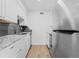 Clean kitchen with white cabinets, granite counters, and stainless steel appliances at 3663 S Sheridan Blvd # I8, Denver, CO 80235