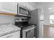 Modern kitchen features stainless steel appliances and granite countertops at 3663 S Sheridan Blvd # I8, Denver, CO 80235