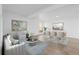 Bright living room with modern decor, light wood floors, and an adjacent dining area perfect for entertaining guests at 3663 S Sheridan Blvd # I8, Denver, CO 80235