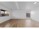 Living room with two windows, laminate flooring, and neutral walls at 3663 S Sheridan Blvd # I8, Denver, CO 80235