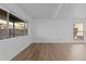 Spacious living room with large windows and laminate floors at 3663 S Sheridan Blvd # I8, Denver, CO 80235