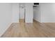 Living room with kitchen view and laminate wood flooring at 3663 S Sheridan Blvd # I8, Denver, CO 80235