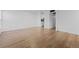 Bright living room with light wood laminate flooring and access to kitchen at 3663 S Sheridan Blvd # I8, Denver, CO 80235