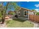 Green home featuring a backyard with a patio, a wooden deck, and manicured lawn at 16257 E 105Th Cir, Commerce City, CO 80022