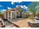 Green home featuring a backyard with a wooden deck, a fire pit and a patio at 16257 E 105Th Cir, Commerce City, CO 80022