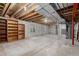 Unfinished basement with exposed ceiling, concrete walls and built-in shelving at 16257 E 105Th Cir, Commerce City, CO 80022