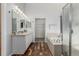 Bathroom featuring double sinks, shower, and soaking tub at 16257 E 105Th Cir, Commerce City, CO 80022