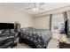 Neutral bedroom featuring a ceiling fan, window, and a desk workstation at 16257 E 105Th Cir, Commerce City, CO 80022