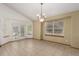 Bright dining area with a chandelier, tile flooring, and glass doors leading to an outdoor space at 16257 E 105Th Cir, Commerce City, CO 80022