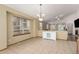 Bright dining area with tile flooring, a chandelier, and large windows providing ample natural light at 16257 E 105Th Cir, Commerce City, CO 80022