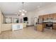 Open-concept dining area with tile flooring, seamlessly connecting to the living room and kitchen at 16257 E 105Th Cir, Commerce City, CO 80022
