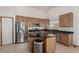Open concept kitchen with stainless steel appliances and a kitchen island at 16257 E 105Th Cir, Commerce City, CO 80022
