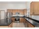 Bright kitchen with stainless steel appliances, an island, and light wood cabinetry at 16257 E 105Th Cir, Commerce City, CO 80022