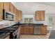 Updated kitchen featuring stainless steel appliances and dark countertops at 16257 E 105Th Cir, Commerce City, CO 80022