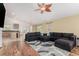 Open-concept living room and kitchen area with hardwood floors, a plush sectional, and natural light at 16257 E 105Th Cir, Commerce City, CO 80022