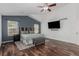 Bright main bedroom featuring wood floors, ceiling fan and accent wall at 16257 E 105Th Cir, Commerce City, CO 80022