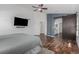 Spacious main bedroom features wood floors, ceiling fan, and ensuite bathroom at 16257 E 105Th Cir, Commerce City, CO 80022