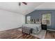Cozy main bedroom with wood floors, accent wall, and natural lighting at 16257 E 105Th Cir, Commerce City, CO 80022