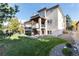 Expansive backyard with a covered deck, lush lawn, and well-maintained landscaping at 9629 Silent Hills Ln, Lone Tree, CO 80124