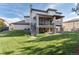 Well-maintained backyard with patio, lush lawn, and mature trees, perfect for outdoor enjoyment at 9629 Silent Hills Ln, Lone Tree, CO 80124