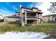 Backyard view with a deck, patio, green lawn and a fence offering privacy and space for outdoor activities at 9629 Silent Hills Ln, Lone Tree, CO 80124