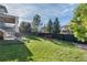 Spacious and green backyard with mature trees, offering privacy and plenty of room to enjoy at 9629 Silent Hills Ln, Lone Tree, CO 80124