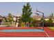 Brightly colored basketball court with playground in a well maintained community at 9629 Silent Hills Ln, Lone Tree, CO 80124