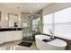 Luxurious bathroom featuring a soaking tub, walk-in shower, and vanity with modern fixtures and finishes at 9629 Silent Hills Ln, Lone Tree, CO 80124