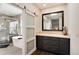 Relaxing bathroom with a modern tub, elegant vanity, and a sliding door, offering a serene spa-like experience at 9629 Silent Hills Ln, Lone Tree, CO 80124