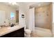 Traditional bathroom with a dark vanity, tile flooring and shower featuring neutral tones and a window view at 9629 Silent Hills Ln, Lone Tree, CO 80124