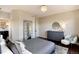 Cozy bedroom featuring a large bed, decorative mirrors, and dark hardwood floors at 9629 Silent Hills Ln, Lone Tree, CO 80124