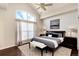 Bright bedroom with vaulted ceilings, large window, modern décor, and a comfortable bed with dark wood floors at 9629 Silent Hills Ln, Lone Tree, CO 80124