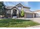 Attractive brick home featuring a well-kept lawn, charming entrance, and a spacious garage, offering comfortable living at 9629 Silent Hills Ln, Lone Tree, CO 80124