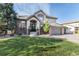 Charming two-story home with brick accents, mature trees, and a well-manicured lawn at 9629 Silent Hills Ln, Lone Tree, CO 80124