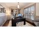 Stylish home office with custom built-ins, hardwood floors, plantation shutters, and contemporary lighting at 9629 Silent Hills Ln, Lone Tree, CO 80124