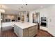 Modern kitchen with large island, stainless steel appliances and sleek white cabinetry at 9629 Silent Hills Ln, Lone Tree, CO 80124