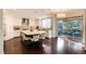 Spacious kitchen with large island, modern appliances, wood floors and deck access at 9629 Silent Hills Ln, Lone Tree, CO 80124