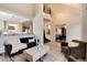 Open-concept living area with staircase, chandelier, and views into the front entrance at 9629 Silent Hills Ln, Lone Tree, CO 80124