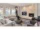 Cozy living room with stone accent wall, fireplace, and neutral furnishings at 9629 Silent Hills Ln, Lone Tree, CO 80124