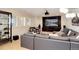 Comfortable living room with a large screen TV and a plush gray sectional sofa at 9629 Silent Hills Ln, Lone Tree, CO 80124