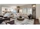 Open-concept living room showcasing seamless flow into the modern kitchen and dining area at 9629 Silent Hills Ln, Lone Tree, CO 80124