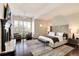 Spacious main bedroom featuring a fireplace, sitting area, and large windows with natural light at 9629 Silent Hills Ln, Lone Tree, CO 80124
