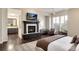 Open-concept main bedroom with fireplace, sitting area, and ensuite bathroom access at 9629 Silent Hills Ln, Lone Tree, CO 80124