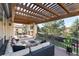 Spacious outdoor patio with fire pit, dining area, grill and views of lush landscaping at 9629 Silent Hills Ln, Lone Tree, CO 80124