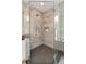 Modern shower featuring contemporary tile, multiple shower heads, and a built-in niche for toiletries at 9629 Silent Hills Ln, Lone Tree, CO 80124